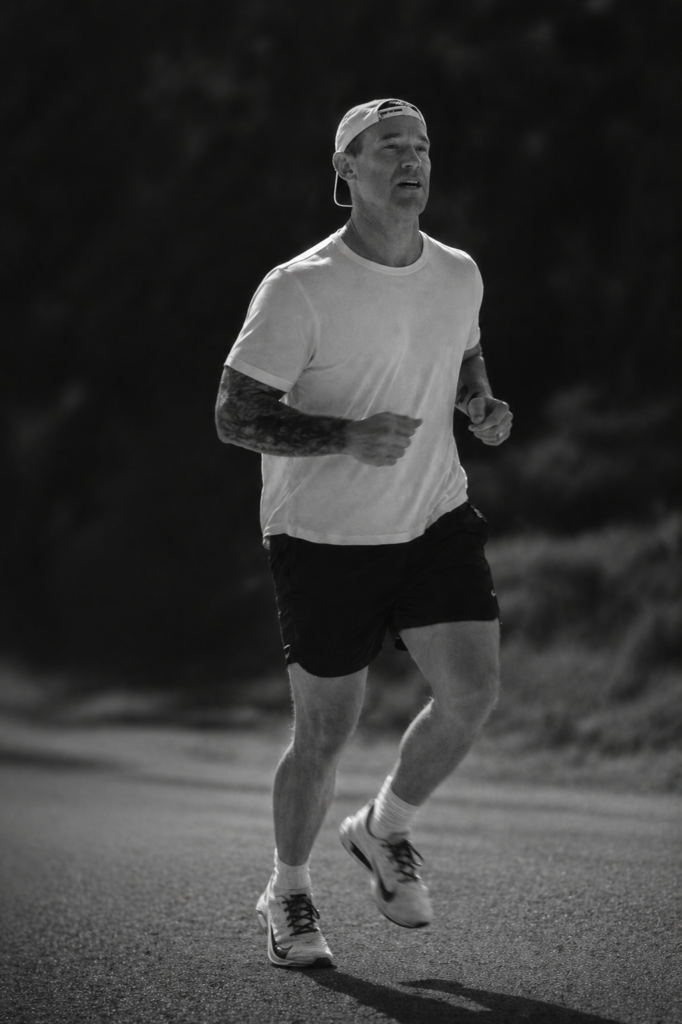 Robb Pollard running on a road during his walk across America
